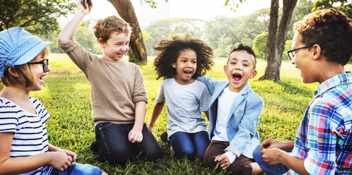 kids smiling in a circle playing