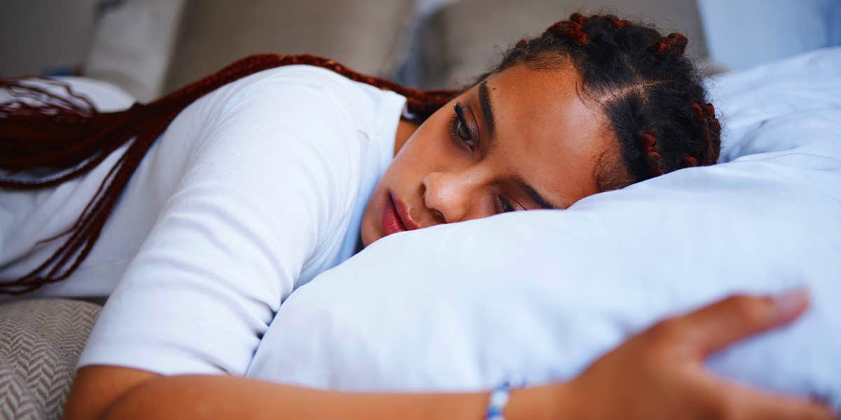The Killer Of Many Relationships No One Ever Talks About sad woman laying in bed