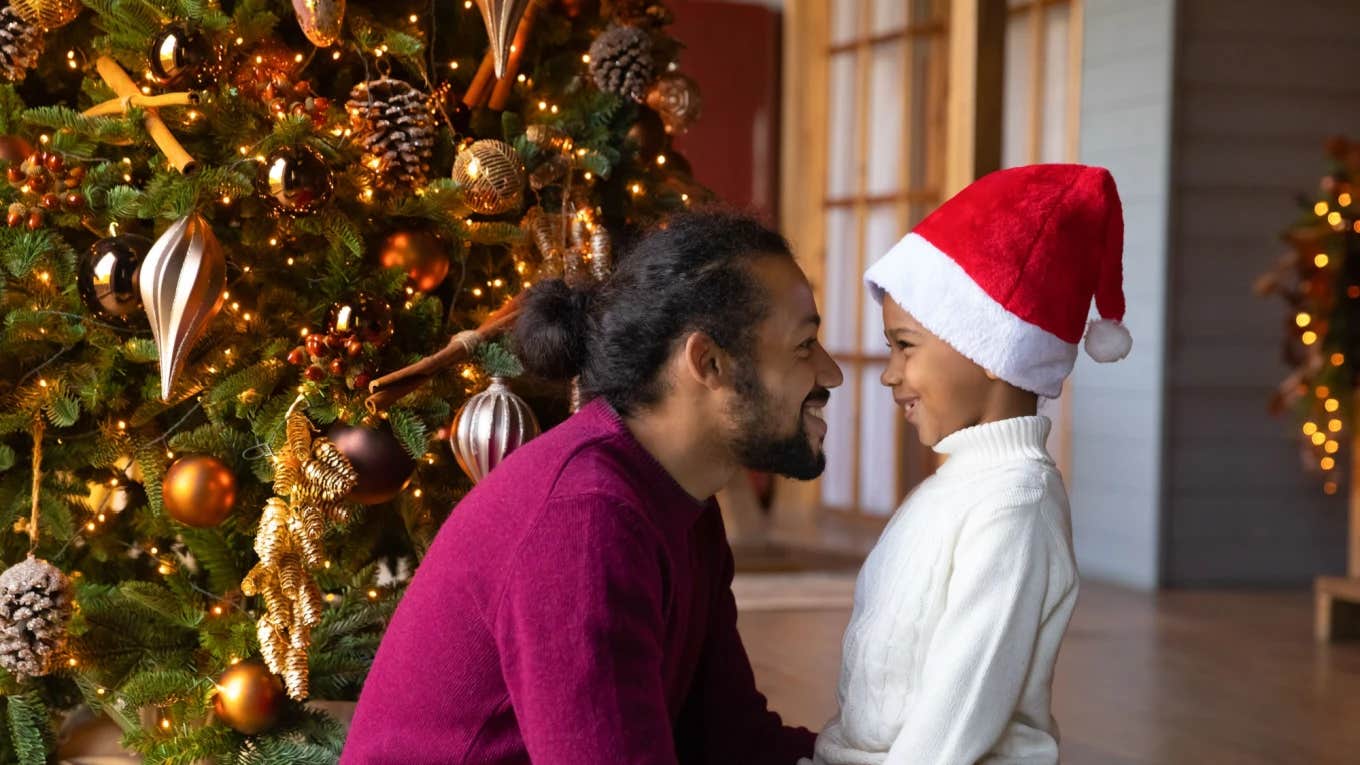 dad smiles at his son on christmas