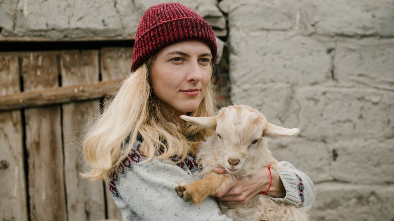 woman holding a goat