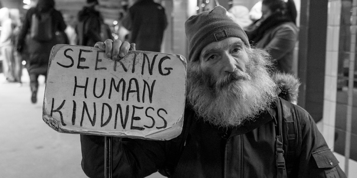 homeless man holding sign