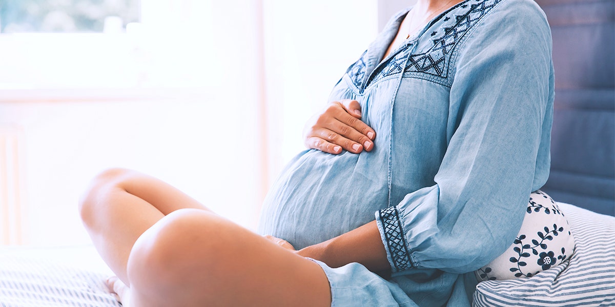 pregnant woman holding belly