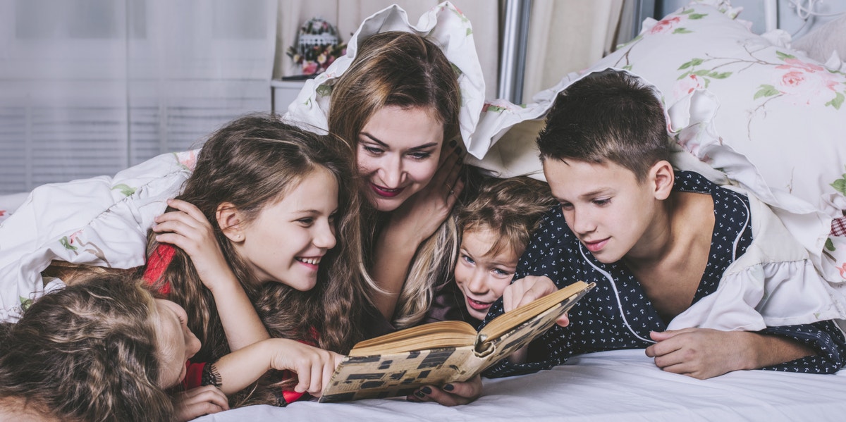 mom with multiple children reading 