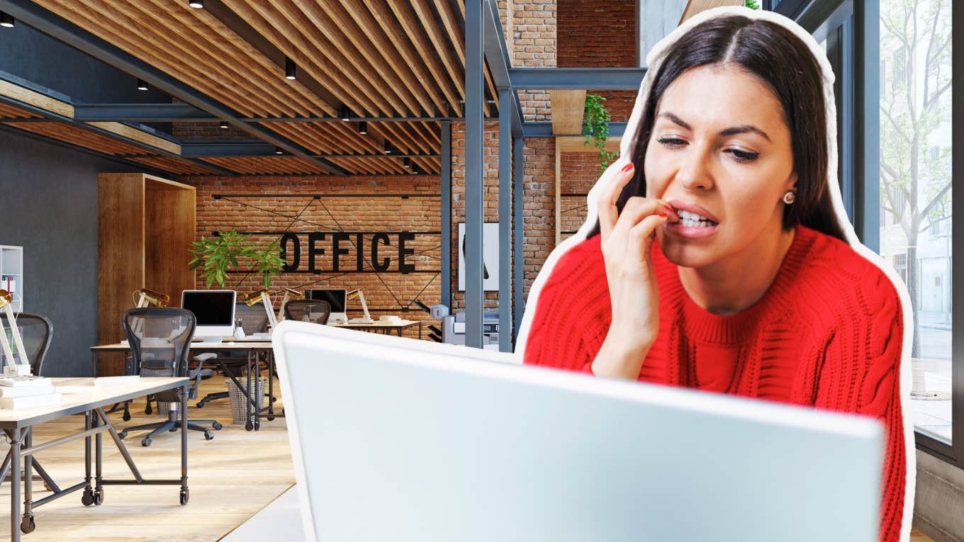 Woman biting her nails at work, worried