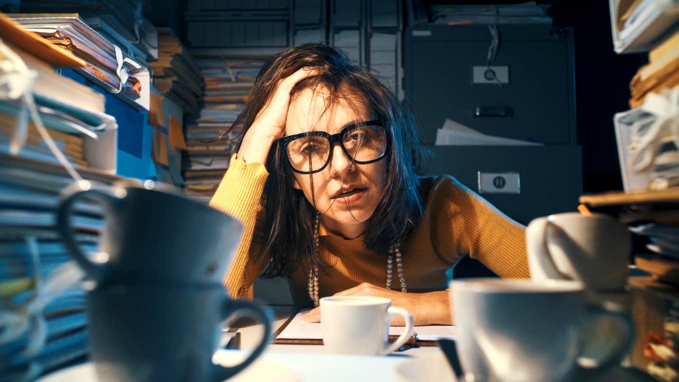 overwhelmed woman sitting at her desk