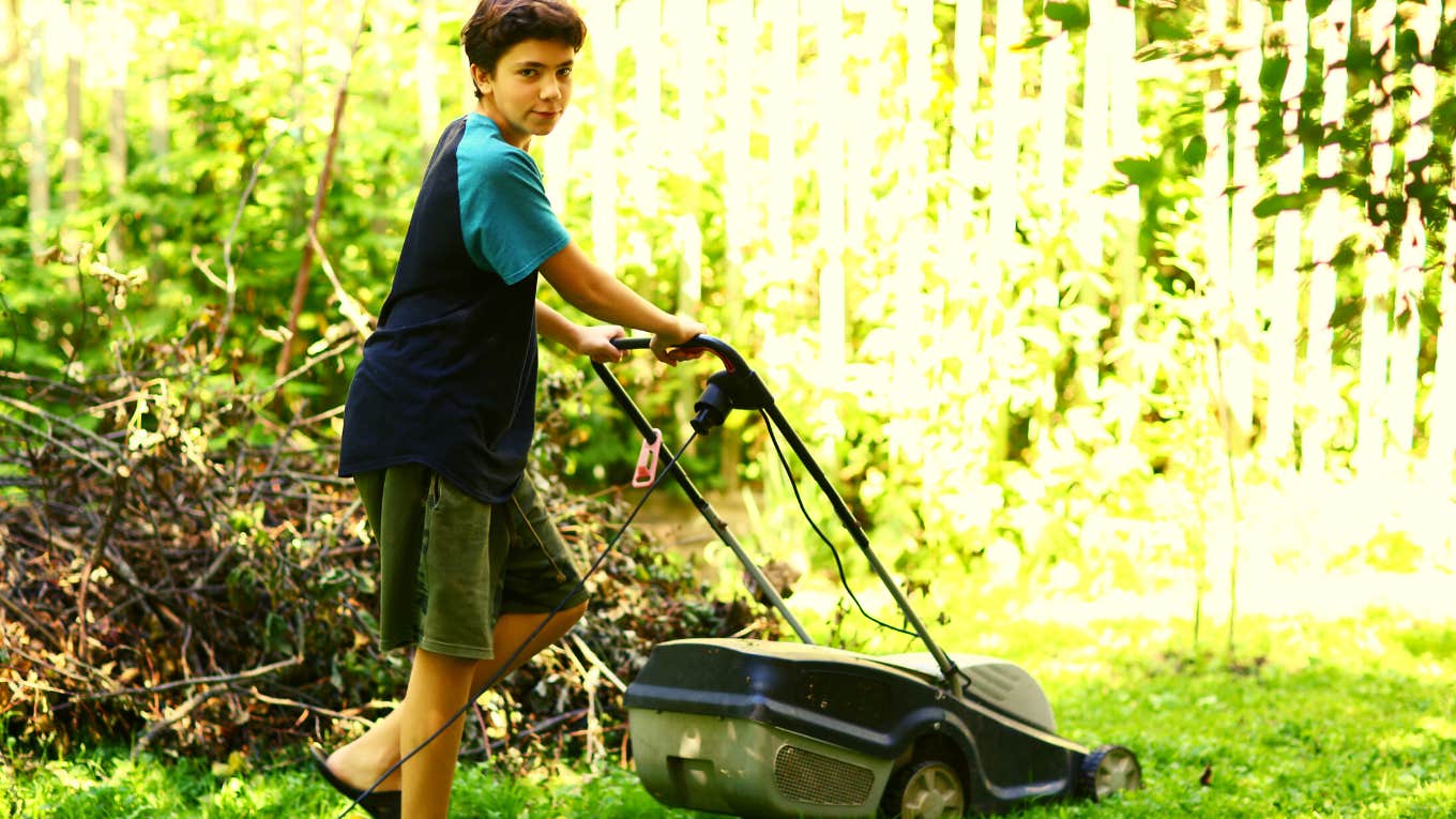 teenage son using a lawnmower