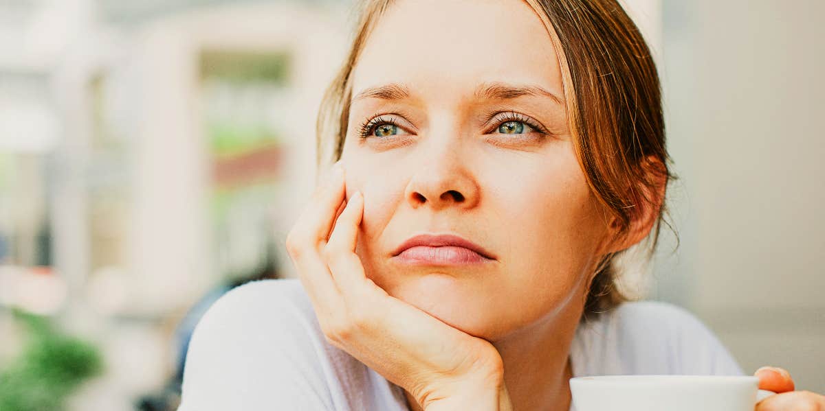 Pensive woman looks in the distance.