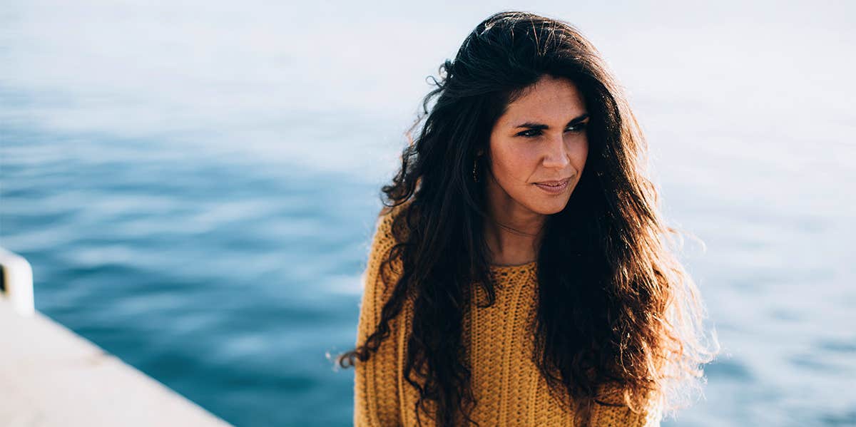 woman sitting by water