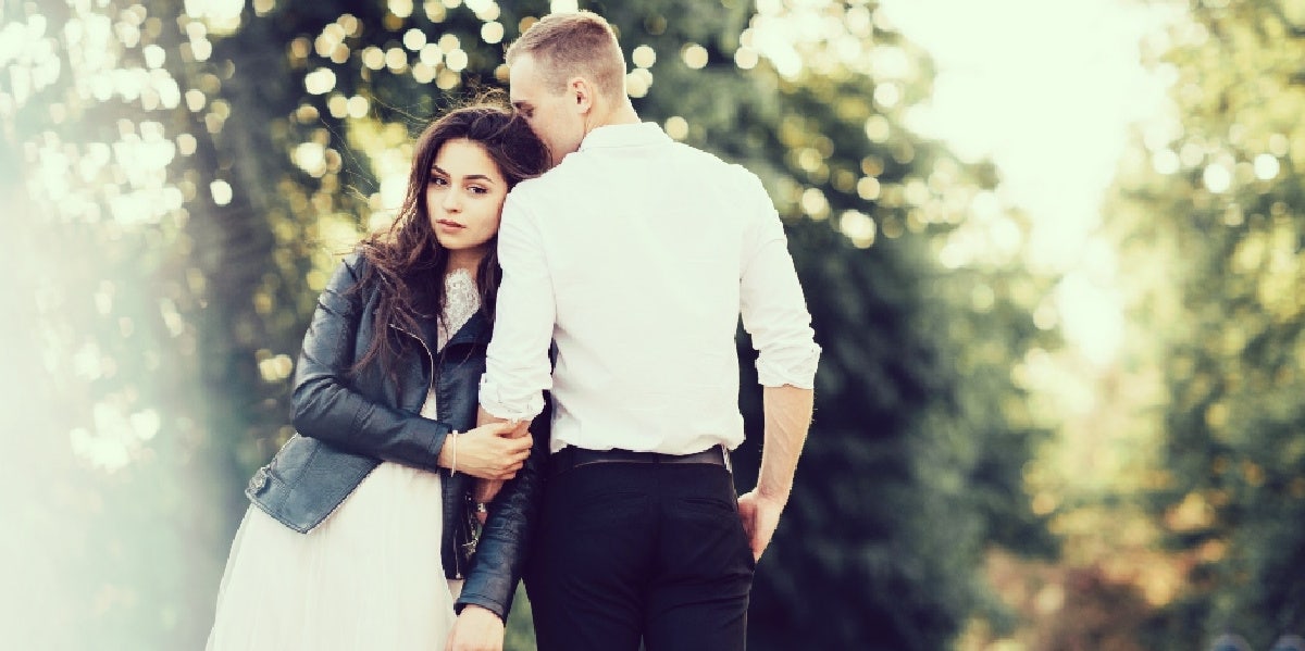 woman turned away from man leaning on him