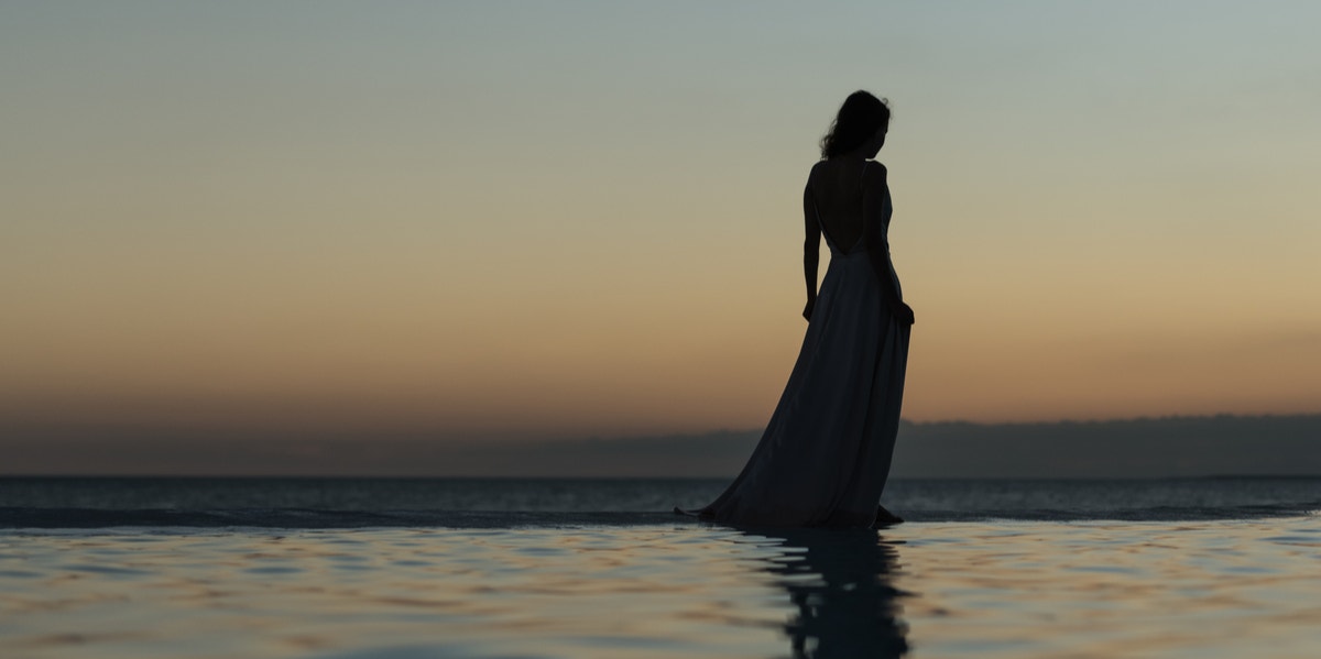 woman walking by water