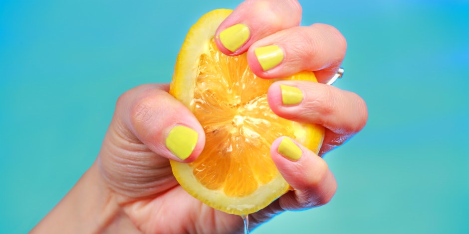 hand squeezing a lemon