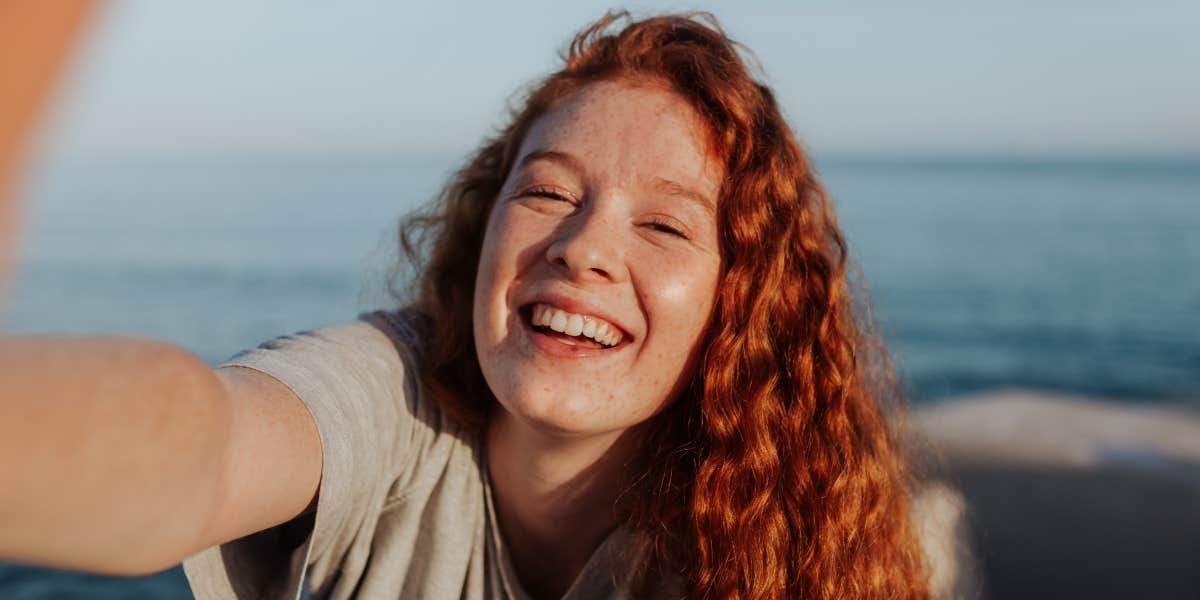 Red-haired young woman laughing freely