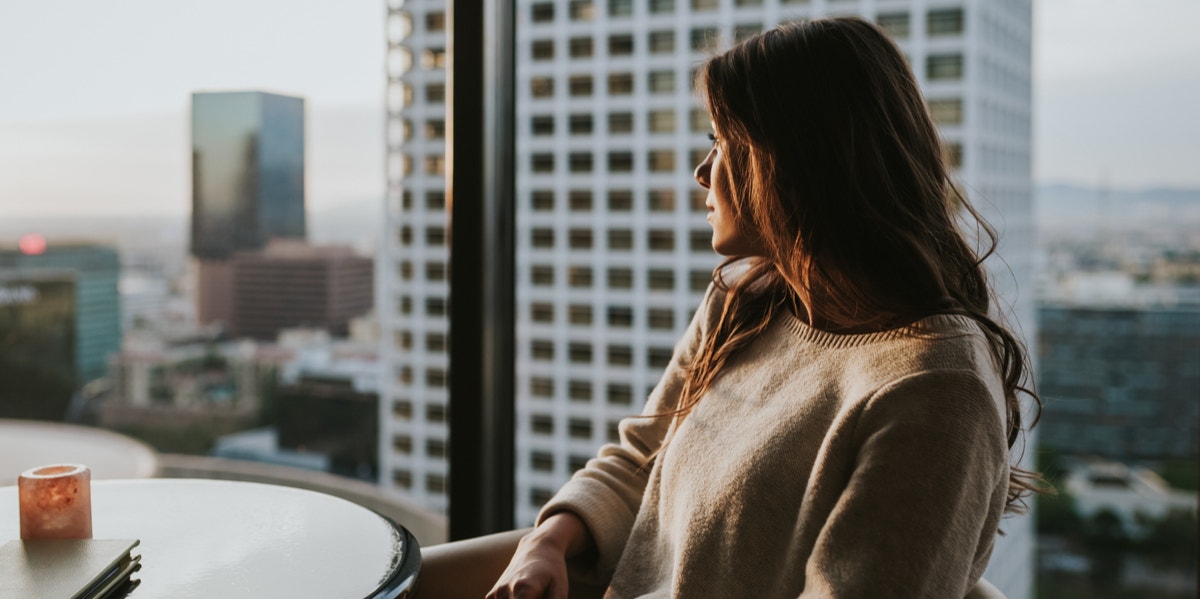 woman looking out window