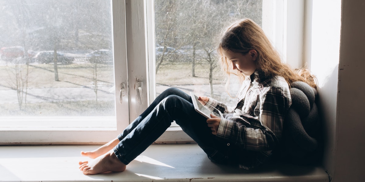 woman sitting next to window