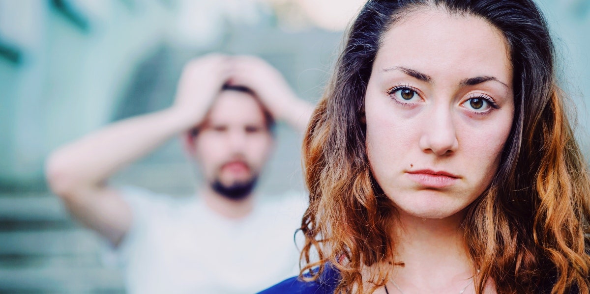 sad woman with distressed man behind her