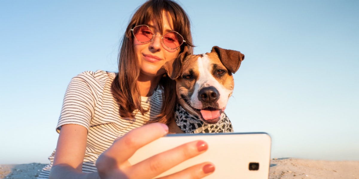 woman taking selfie with dog