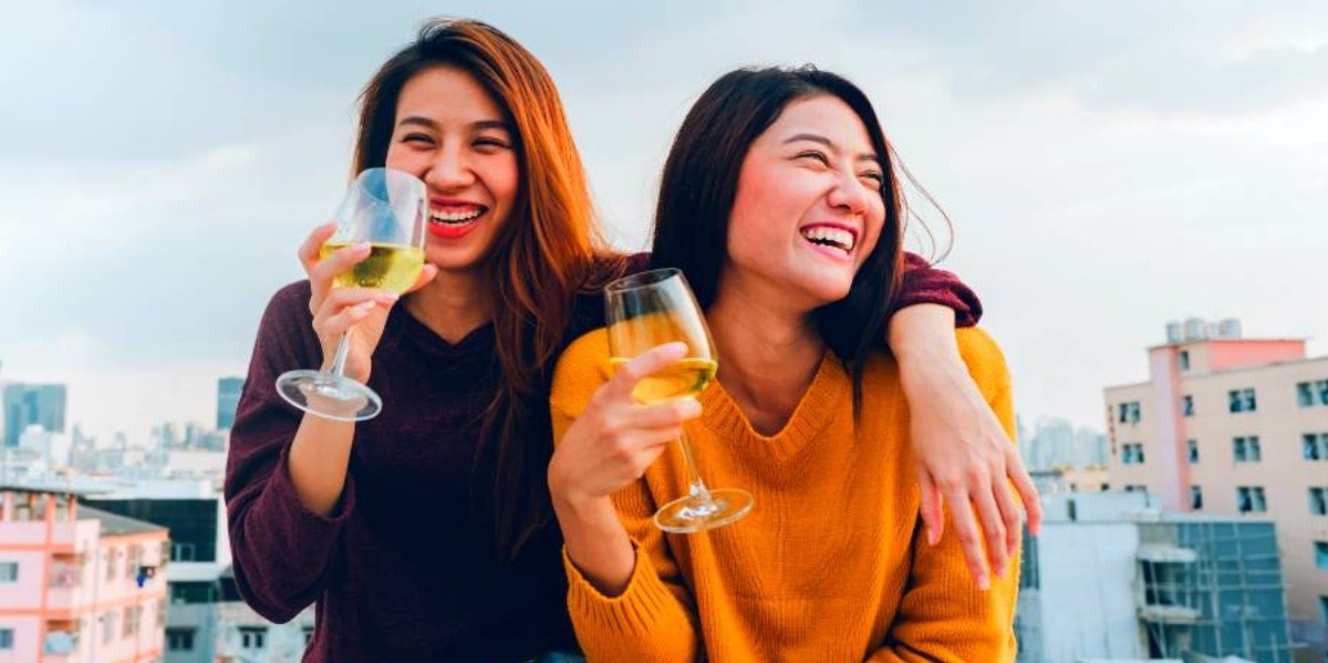 11 Life Hacks For Building Resilience In Stressful Times two women laughing and drinking