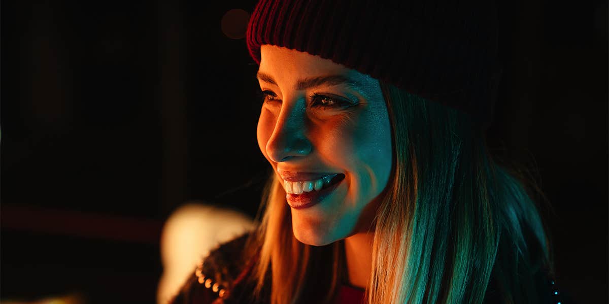 smiling woman at night