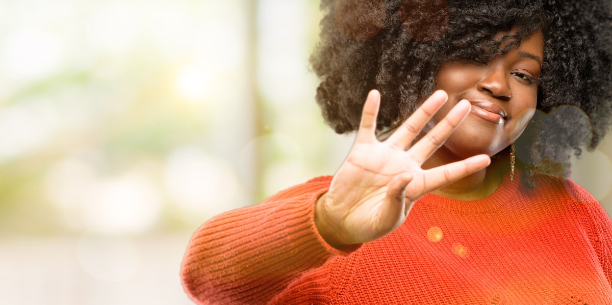 woman holding up 4 fingers