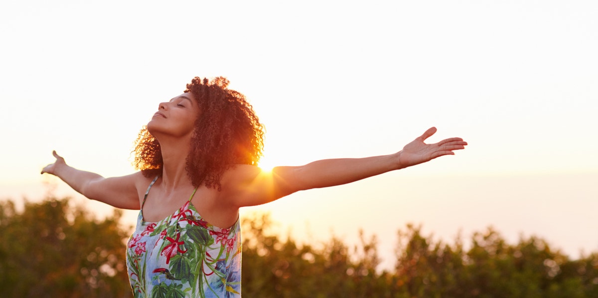 confident woman with arms stretched out to each side