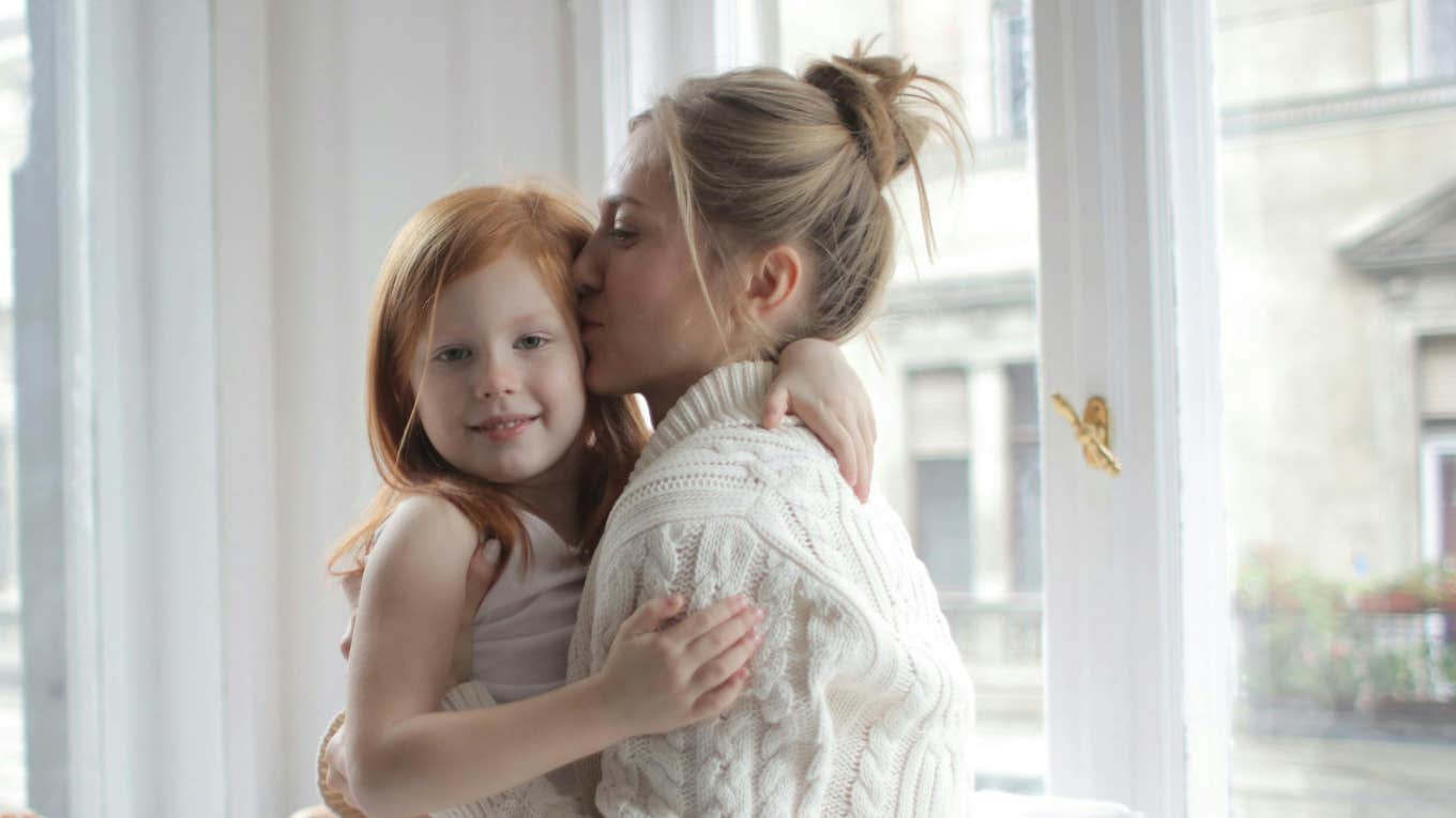 mom embracing daughter 