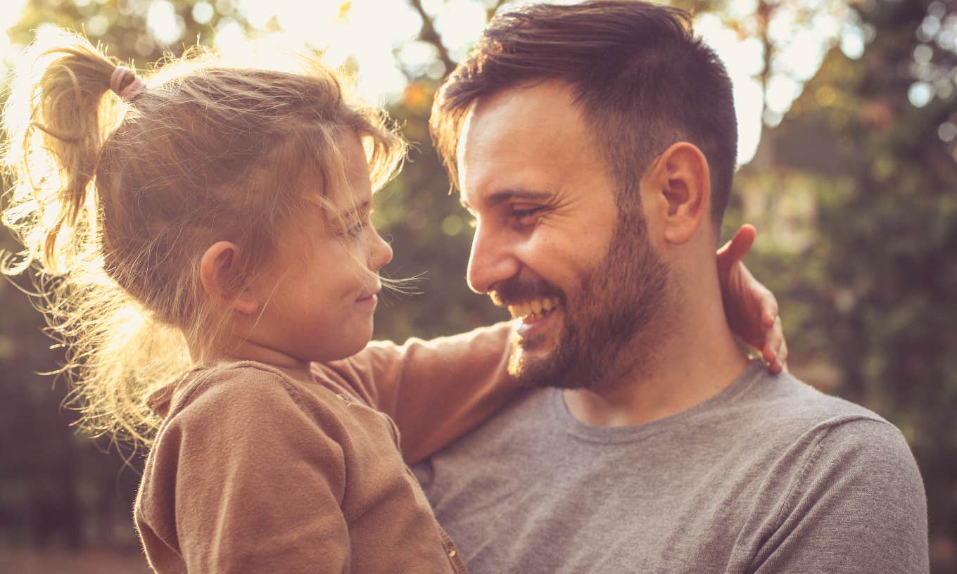 Father and daughter smiling at each other