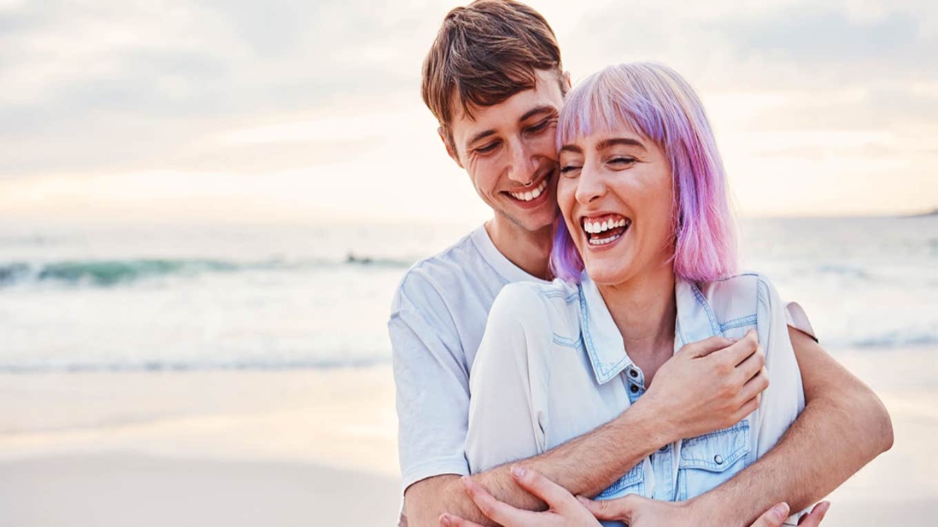 couple hugging on the beach smiling