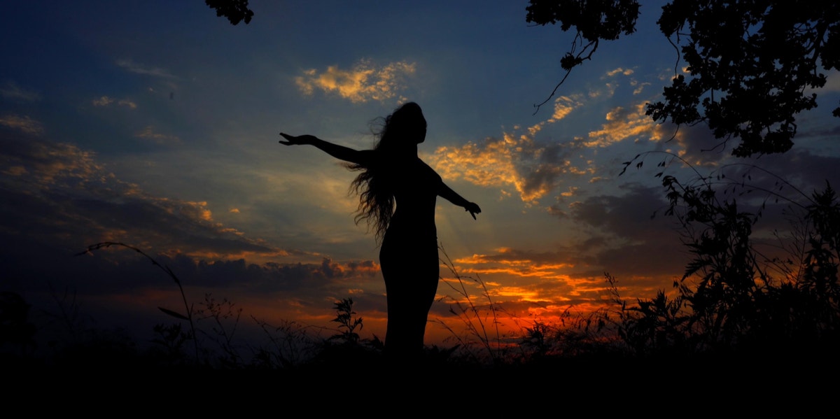 woman in sunset meditating