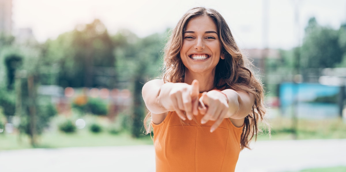 woman smiling and pointing