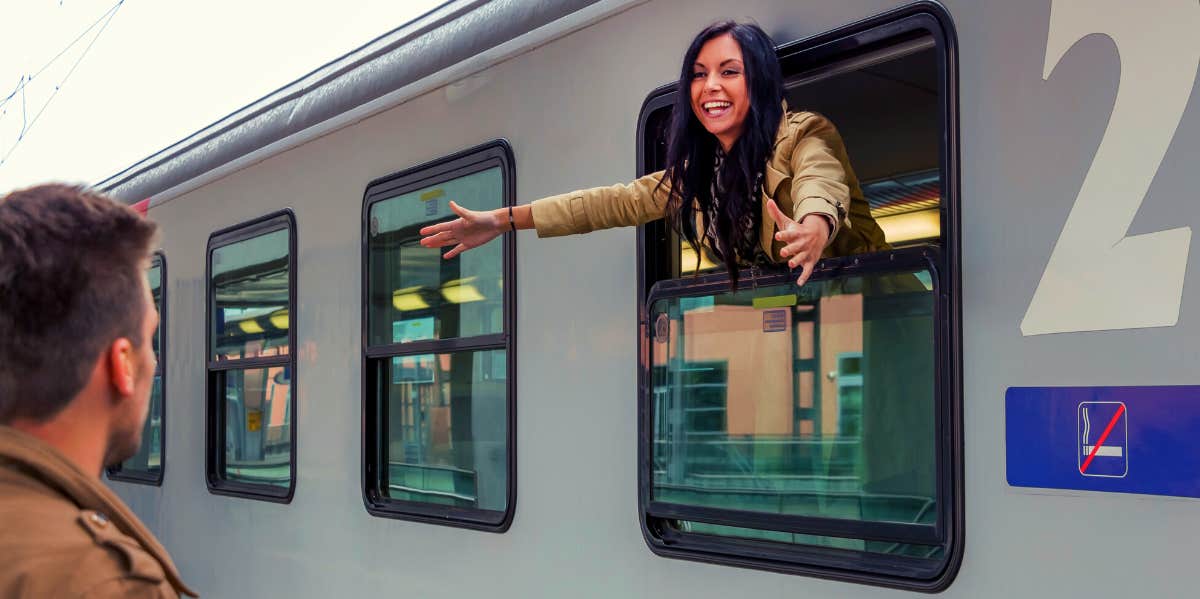 woman greeting long distance boyfriend from a train