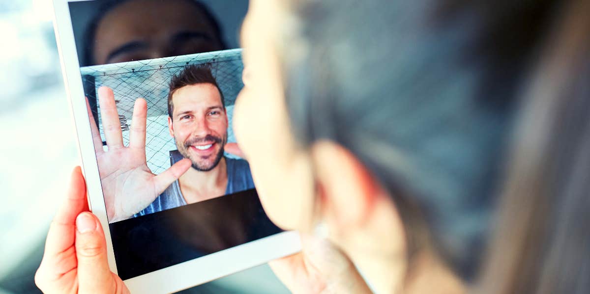 woman looking at boyfriend on ipad