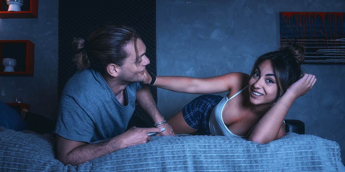 playful couple on bed