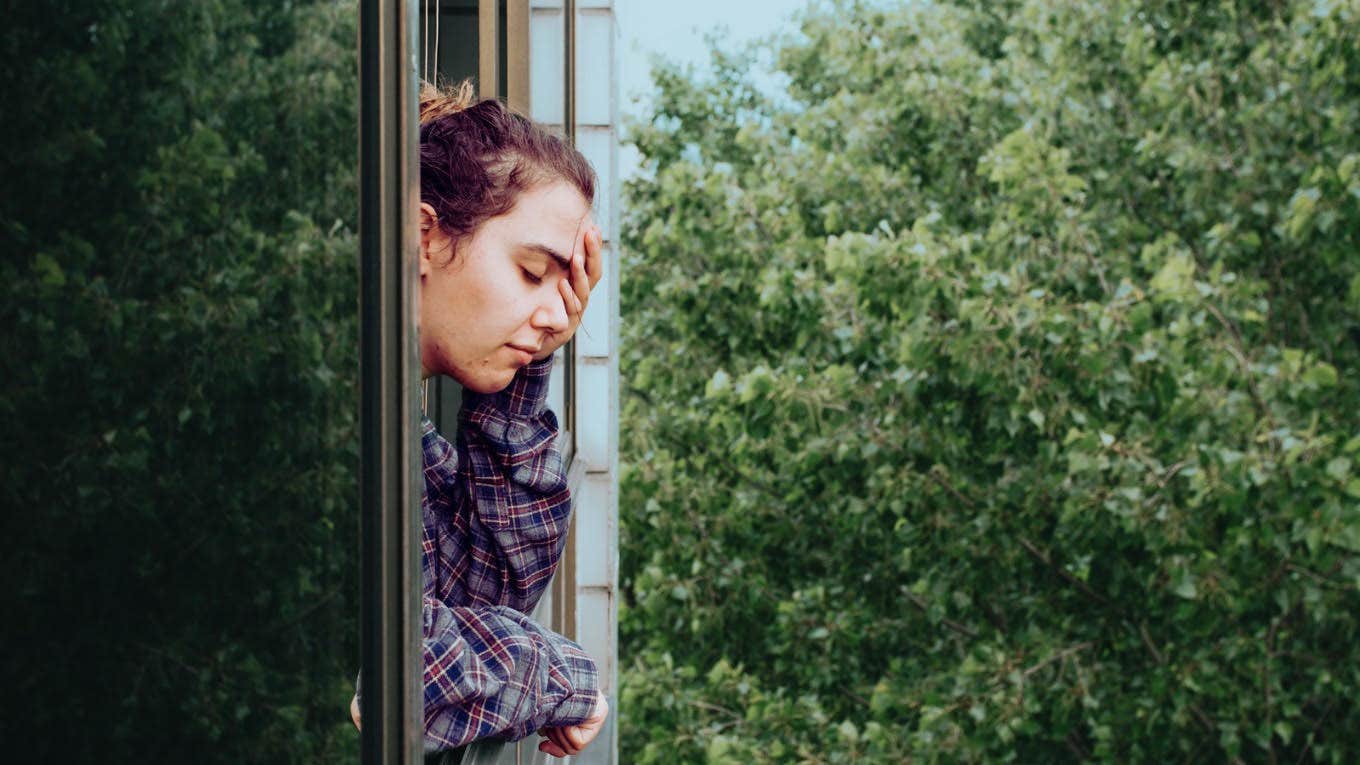 stressed woman looking out the window