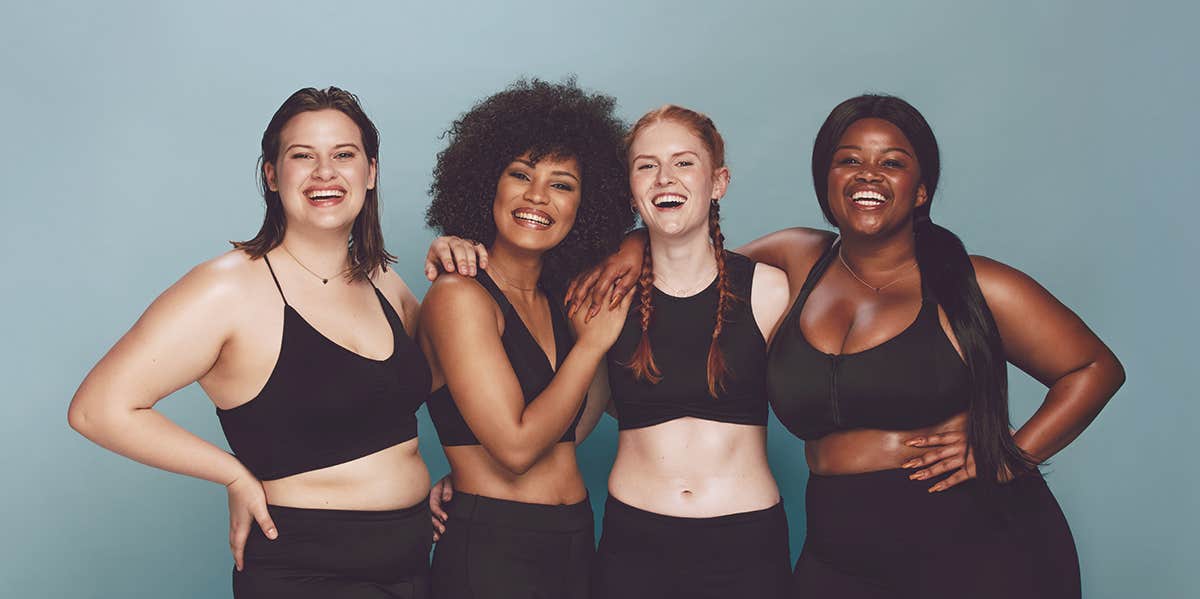 four woman with different skin color and body shape standing together 