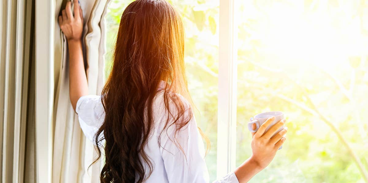 woman looking out window