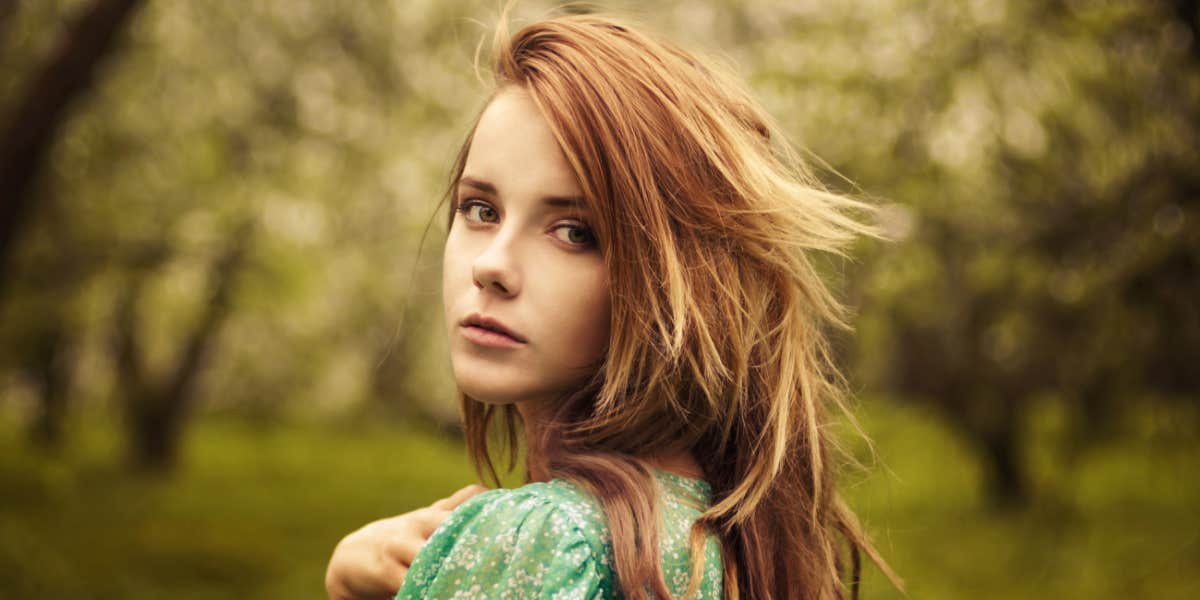 how to function through cumulative grief young strawberry blonde woman outdoors looking serious