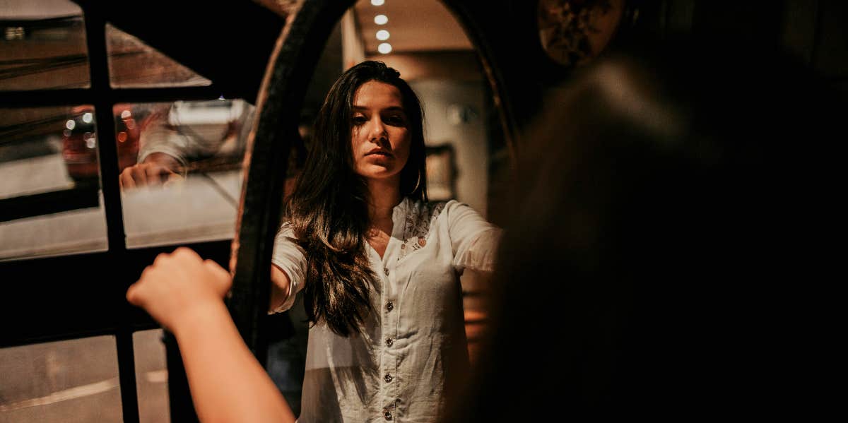 woman looking in mirror