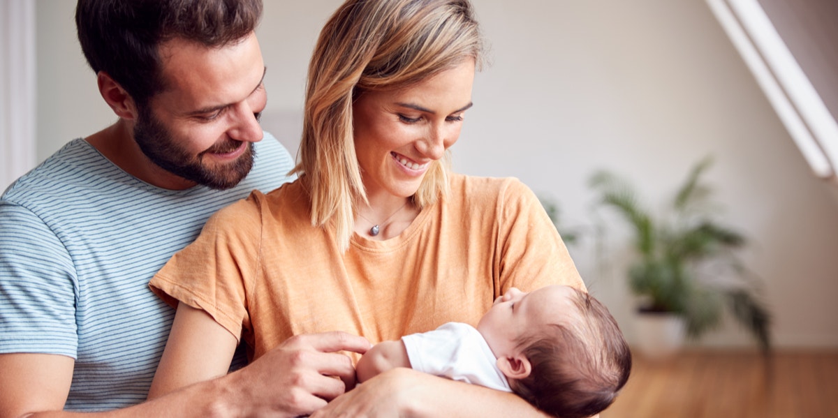 parents holding baby