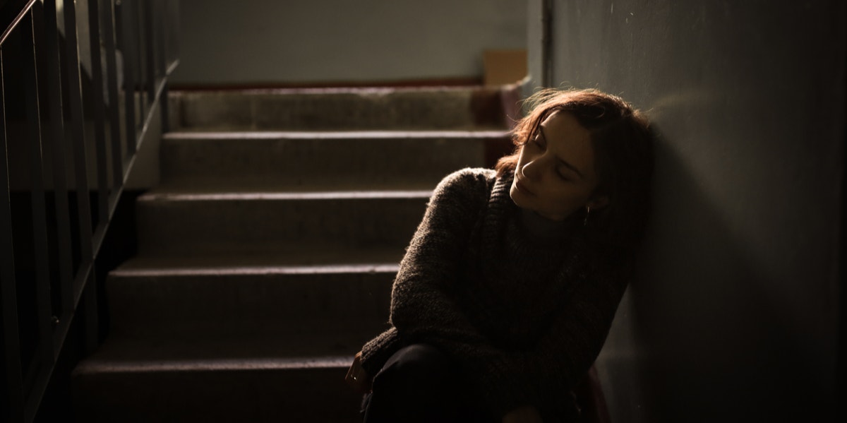 sad woman on stairs