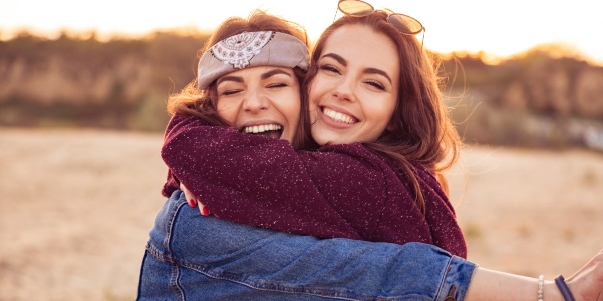 The Harsh Reality Of Losing Your Best Friend To Their Boyfriend two friends smiling hugging