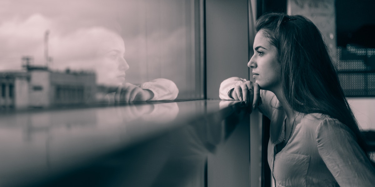 woman looking out window