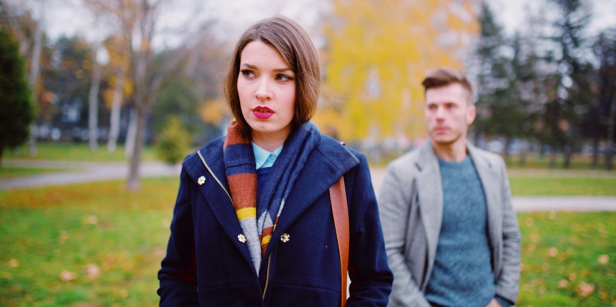 unsure woman with man behind her