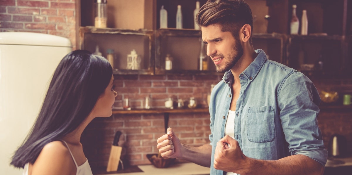 man and woman arguing in kitchen