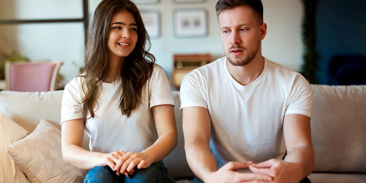 The Mortifying Reason I Didn't Know My Own Boyfriend's Name For An Entire Month Awkward couple sitting on couch