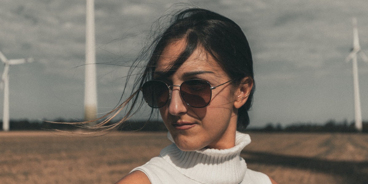woman with sunglasses standing in field