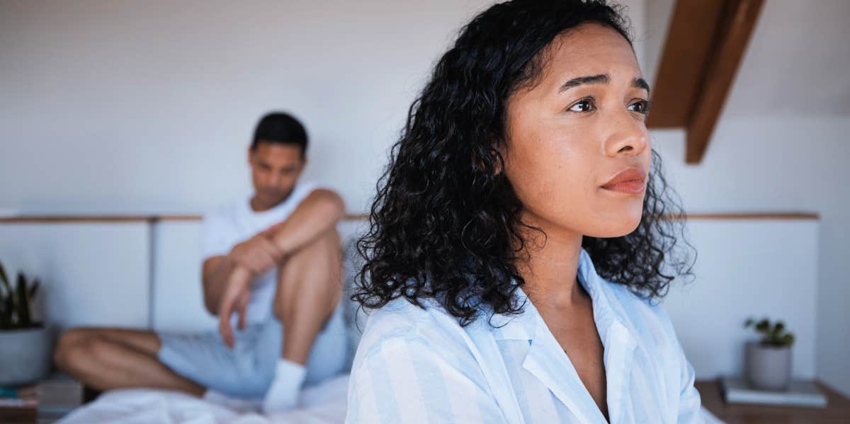 unhappy couple, man sitting behind woman