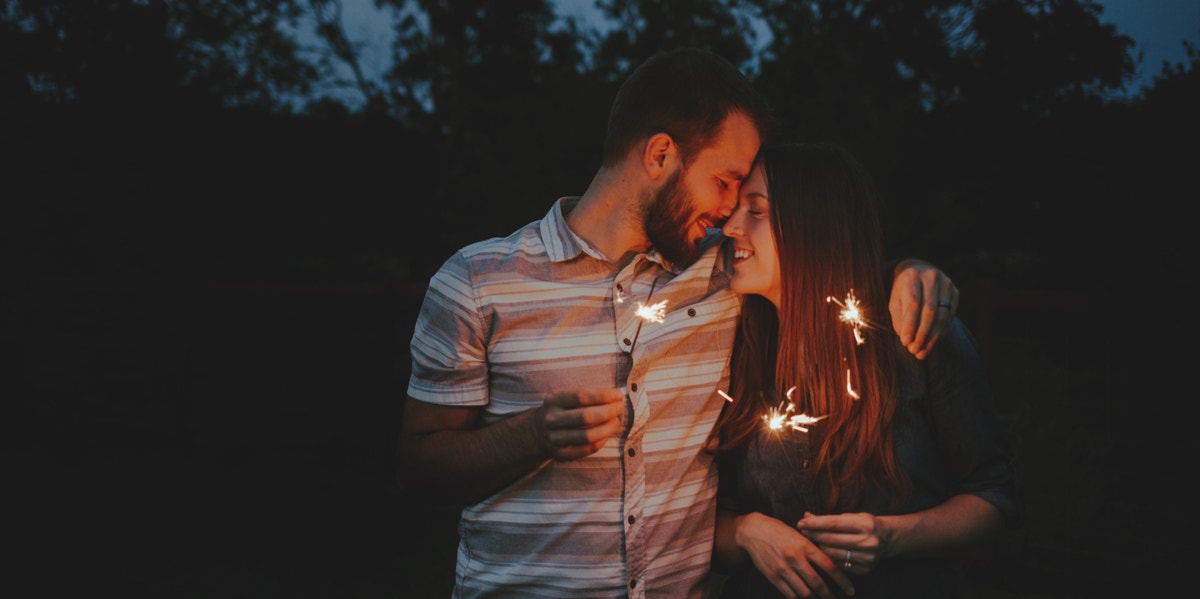 Real Love Doesn't Always Have A Spark, So Stop Waiting For One couple holding sparklers