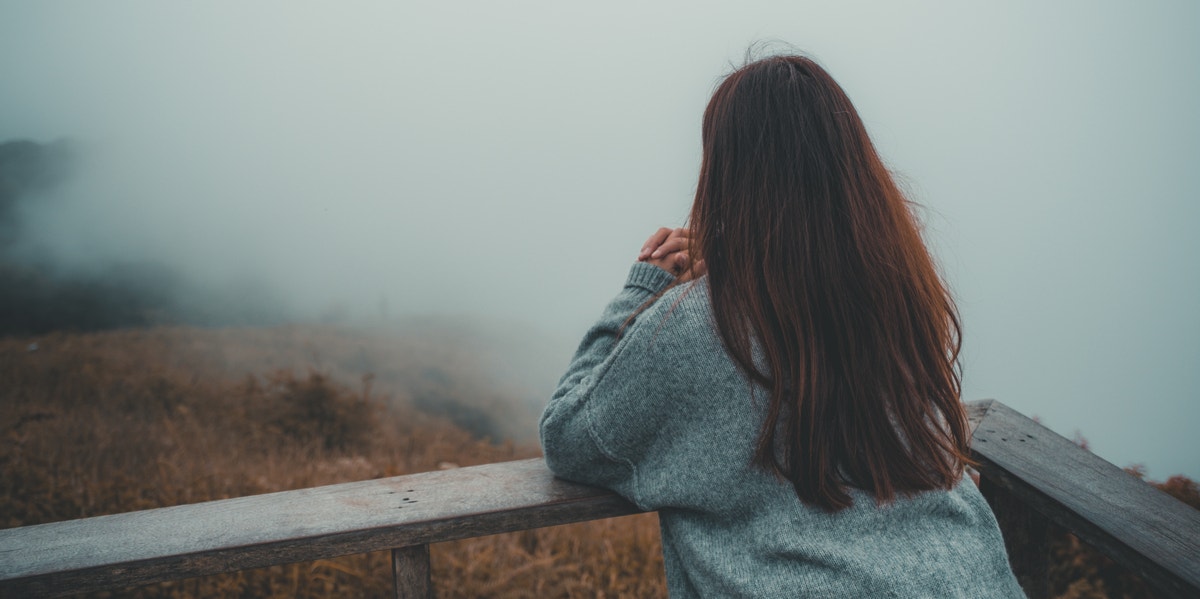 woman looking out into fog