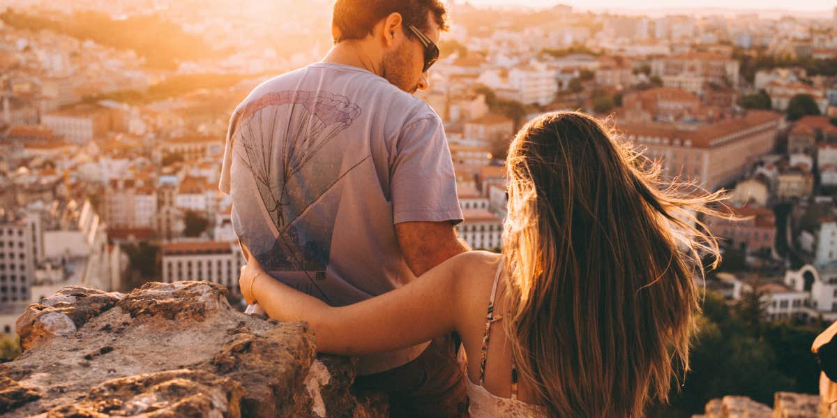 man and woman looking over a city