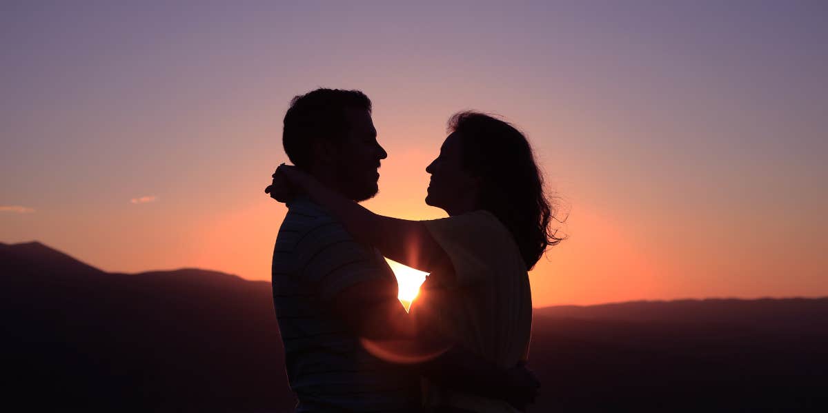 Love Horoscope For December 10, 2023 couple holding each other at sunset